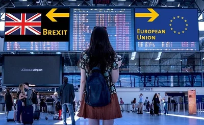 An image of a woman standing in front a sign saying Brexit and EU 