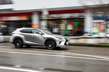 An image of a Toyota car driving down a road