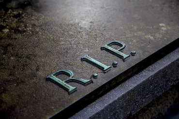 Image of a tombstone with the letters ‘RIP’ on it