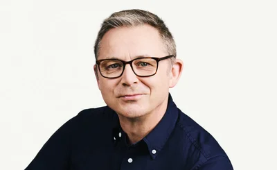 Headshot of Adrian McDermott, CTO, Zendesk, wearing dark shirt