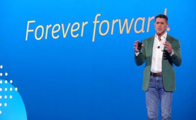 Carl Eschenbach, CEO of Workday, on stage at Workday Rising 2024 with Forever Forward backdrop