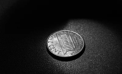 An image of one cent set against a dark background 