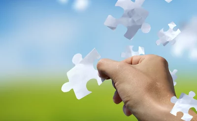 Concept with a man catching a falling puzzle piece.