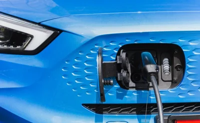 Close-up of blue EV on charge