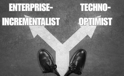 Black businessman shoes in front of arrows facing two ways on gray background