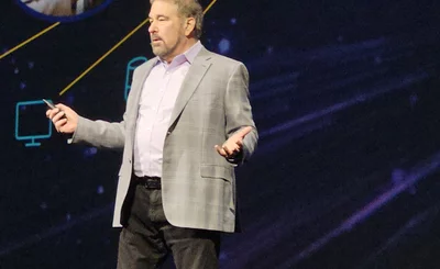 An image of Pega CEO Alan Trefler on stage in Vegas