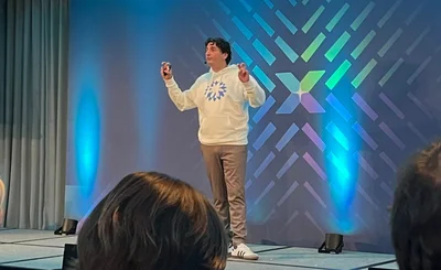 Salvatore Lombardo wearing a white Coupa sweatshirt speaks at Coupa Inspire London 2025