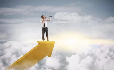 Businessman monitoring through telescope stands on arrow above clouds © alphaspirit - shutterstock
