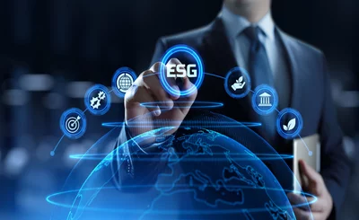 Businessman pressing ESG button on screen showing globe below © SWKStock - shutterstock