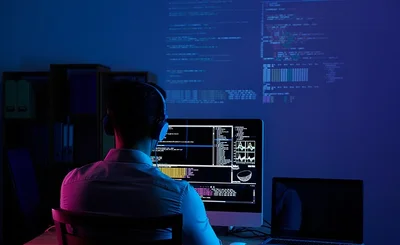 an image of a software developer coding at a computer
