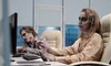Two zombies sat in front of computers 