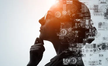 person with glasses in profile with code and graphics in the foreground