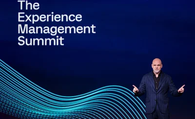 an image of Jason Maynard CEO Qualtrics on stage