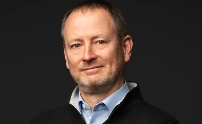 Headshot of Woodson Martin, CEO OutSystems, on a black background